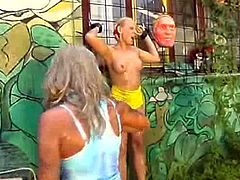 Paul forces a blonde to suck on his dick before he bounds her to a wall. Next, his other blonde slave contributes to getting her dirty. He washes them with a hose before fucking them.