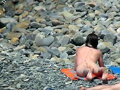 Leggy chick is posing naked on the beach