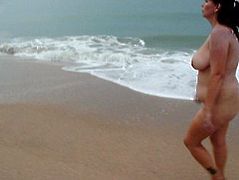Chubby MILF walking nude on the beach