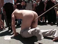 A submissive guy gets tied up and humiliated in the street. A lot of people watch at this rough show. Then Sebastian Keys sucks dicks and gets ass fucked inside some building.