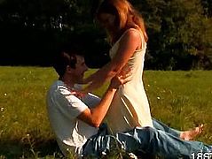 On the bright grass guy kisses a girl