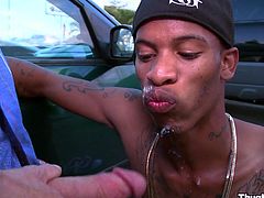 Hot black gay gets his cock sucked in the parking lot and rides a big white cock until her gets his filthy face covered with cum.