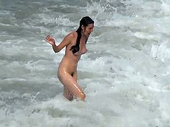 Sexy chick is walking naked on the beach