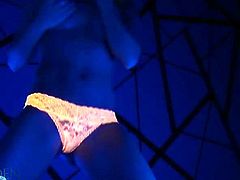 Blonde Madden wears a pair of orange panties and knee-long socks. She puts lotion on her nipples and turns on the black light. She teases with her sexy body.