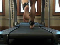This muscular hunk is tied up in shackles and chains and his master makes him get on the treadmill. The gay slave has his ass spanked and his nipples pinched really hard. The pain motivates him to move faster on the treadmill.