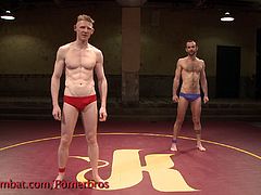 After a nice, fair fight, these muscular gays reach each other's cocks and fuck really hard on the fighting ring.