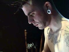 Cotton is a tattooed twink with a funky hairdo and a big stiff cock. He jerks off while watching some porn video and he dumps his load of sperm in his hand.