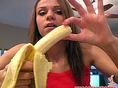 Gorgeous babes solo model with a food fetish and long hair in a sexy top peels a banana and eats it seductively throbbing it deep into her mouth