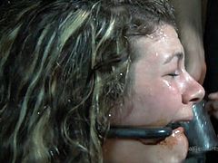 This dirty slut is chained in a grimy and dirty basement. She has a collar around her neck and the chain is attached to her neck from the wall. With her arms locked to her ankles she can barely move in the dungeon.