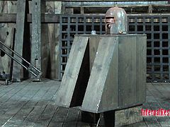 Wenona is locked in a very confining iron torture device. Her master pours water into a funnel attached to the device. She can't take all the water torture, so he give her a break and lets her out for a little air.