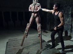 Brock is tied up in rope and tightly bound while he is hanged up on the ceiling. He dangles there, which gives his mean master all the control. The muscular slave gets whipped hard, and he lets out a moan every time he is whipped with the master tools.