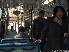 This sexy clerk is coming home from the office on the bus. A man is standing beside her and she accidentally, brushes her hand up against his crotch. Before long his dick is out of his pants hole and she is giving him a public handjob.
