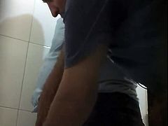 two men jerking in toilet