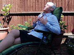 54 year old Fleur has just got home from the office and she is going to relax in her backyard. She sits on her lounge chair and opens her top a little bit, to reveal her massive breasts. The mature slut shows off her sexy pantyhose, too.