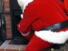 A chap clothed as Santa Claus sucks dong a peasant