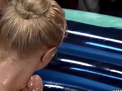 Two sexy blondes get all oiled up and fucked hard in an inflatable.