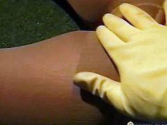 A man in yellow gloves paw her tits
