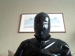 Rubber catsuit and condom on head
