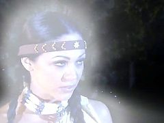 Cherokee is dressed as an indian girl while she is with a guy in the forest by the fire. She is giving a blow job and then we see her offering up her shaved pussy.