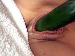 Mature masturbates with a cucumber