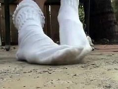 Heidi puts white hooters socks back on her feet after showing bare feet