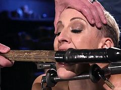 Dylan gets locked up and has her mouth pulled open wide by the master. He makes her do what he wants, and this time she gets a big black dildo shoved down her throat. She chokes and gags, as she is humiliated in bondage.