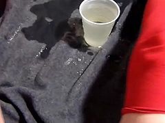 Blonde pissing in a cup