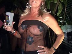 A blue eyed, blonde MILF is wearing a seethrough shirt, allowing everyone to see that she has large hooters and flat nipples. The next woman is too classy to show her nude boobs but she has some fantastic cleavage. Next, a redhead will pull off her top and press her massive, natural knockers together, as if she were going to give you a titty fucking.