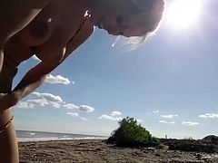 Blonde slut sucks old guys dick on the beach in Florida