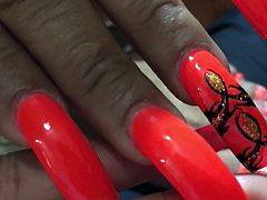 Latina with sexy long orange(different design) nails