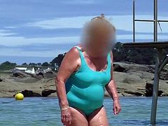 beautiful sexy granny in the wet turquoise swimsuit