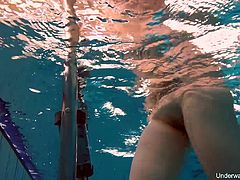 Seductive red haired swimmer Katrin Bulbul gets naked under the water