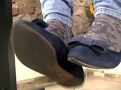 Teen feet in socks with white nail polish