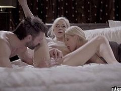 The women perform fellatio on all fours of bed