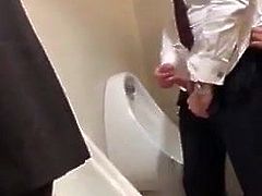 Business men play in public toilet