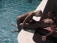 Beautiful blonde with huge tits rides a stiffy by the pool