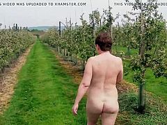 Small titted milf naked walk in the orchard