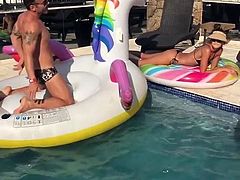 Izabel Goulart outdoors laying by a pool in a bikini