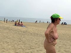 Mature woman walking on the beach naked