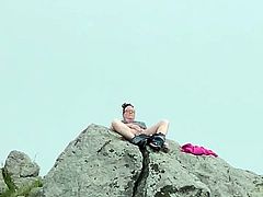 Zoey masturbating in public high up on a rock in the harbor