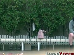 Young Japanese babe filmed toying pussy at a bus stop