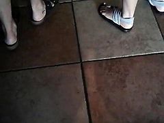 Brunette and blonde feet at cafe